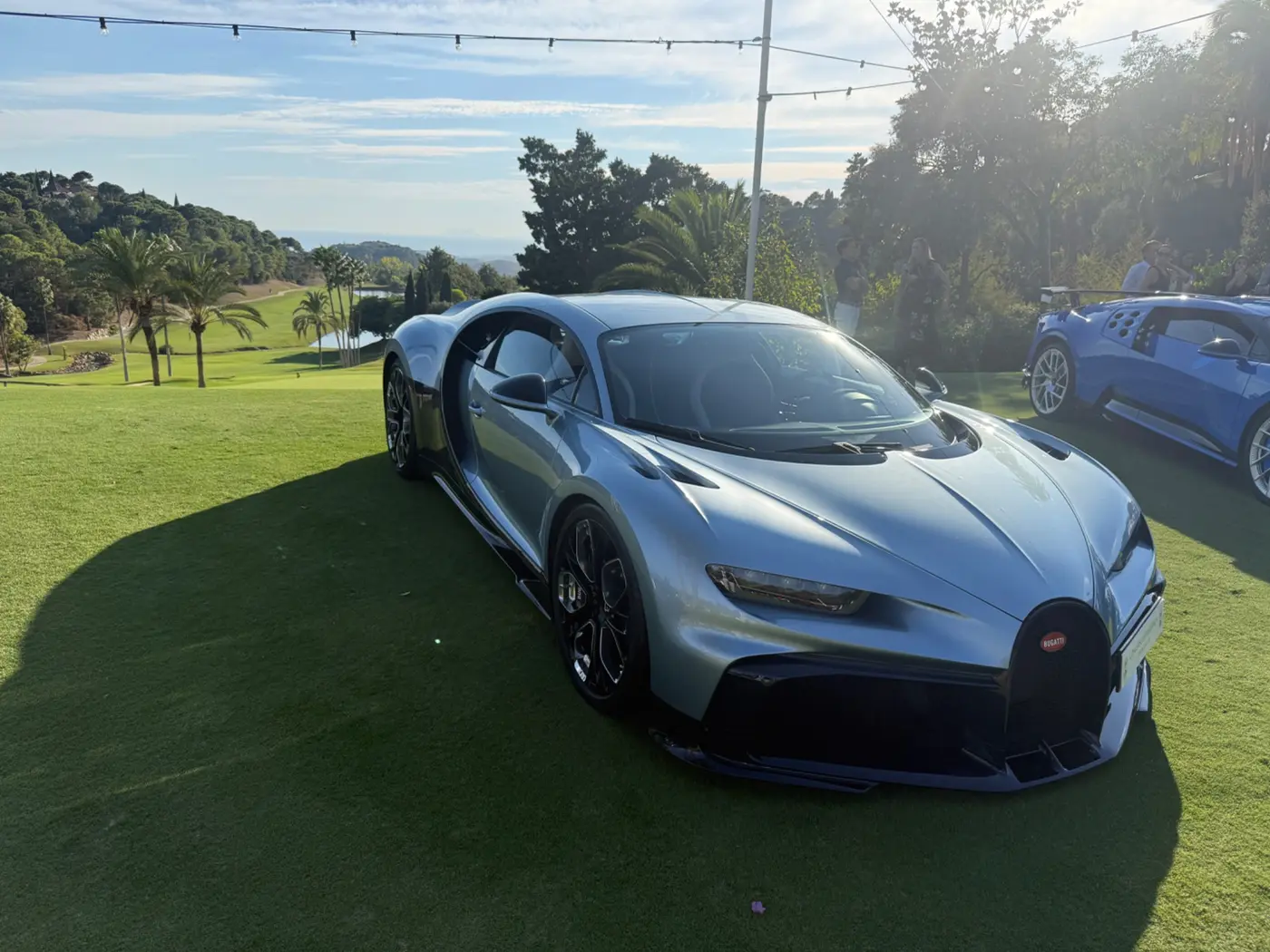 Modern Bugatti hypercar displayed on a concours lawn